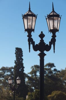 two old lanterns against the blue sky