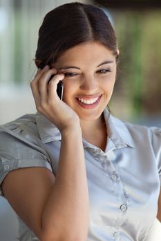 Smiling businesswoman talking on mobile