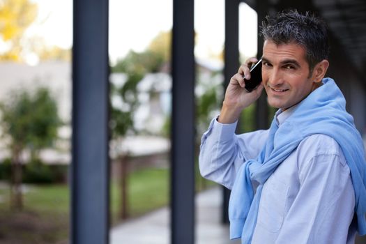 Portrait of handsome guy talking on cell phone