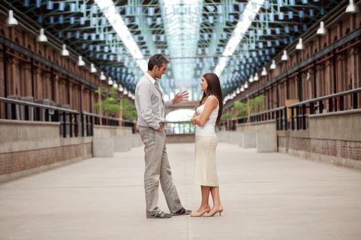 Full length of handsome man talking to beautiful woman