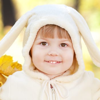 beautiful little girl in costume bunny in the autumn forest