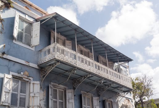 Old delapidated house in the old town of Charlotte Amalie St Thomas USVI with ornate balcony
