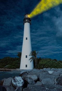 Cape Florida Lighthouse and Lantern in Bill Baggs State Park in Key Biscayne Florida with light glowing at night