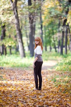 young redhead teenager woman in the forest  