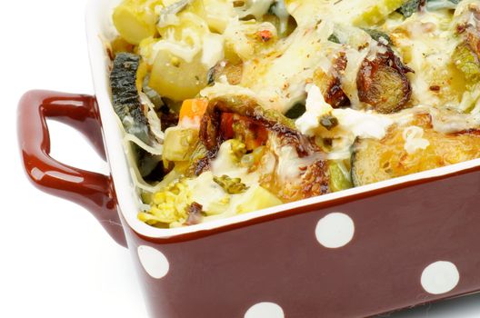 Brown Polka Dot Casserole Dish with Broccoli, Zucchini and Cream Cheese closeup on white background