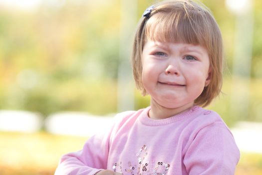 beautiful little girl crying on the autumn forest