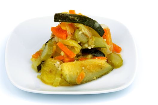 Ragout with Zucchini, Carrot, Leek and Bell Pepper on Square White Plate isolated on white background