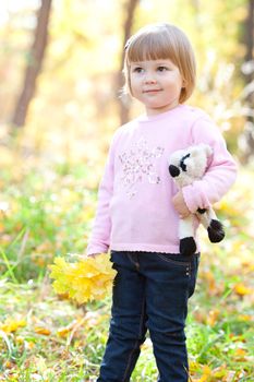 beautiful little girl on the autumn forest