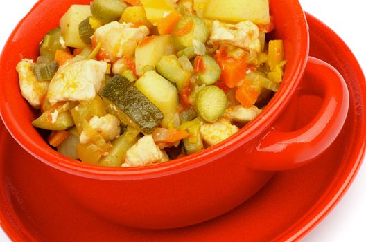 Vegetables and Chicken Ragout with Zucchini, Potato, Carrot, Bell Pepper, Tomatoes, Cabbage and Leek in Red Bowl closeup