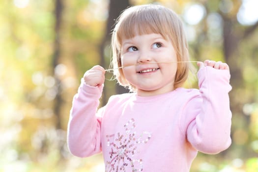 beautiful little girl on the autumn forest