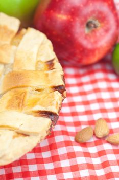 apple pie, apples, cinnamon and almonds on plaid fabric
