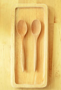 Two wooden spoons on tray