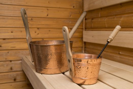 Two buckets for water with ladles in an interior of the Finnish sauna