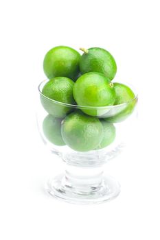 lime in a glass bowl isolated on white