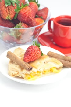 piece of apple pie, cinnamon, a cup of tea and strawberries isolated on white