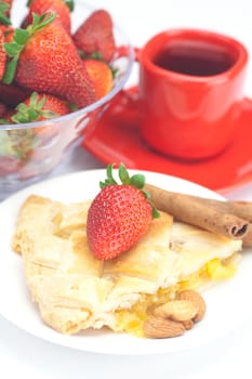 piece of apple pie, cinnamon, a cup of tea and strawberries isolated on white