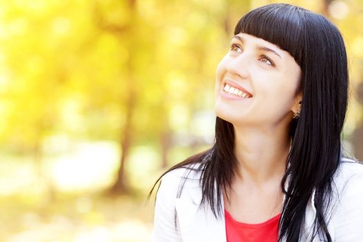 portrait of a beautiful young woman in autumn forest