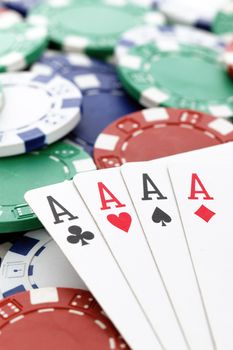 poker, four aces of a kind with chips background