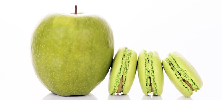 green apple with macaroons on white background, panoramic