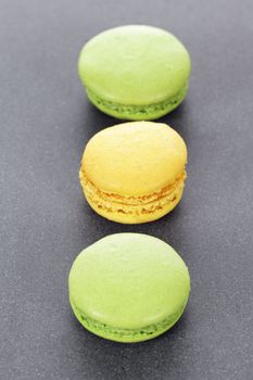 three green and yellow macaroons in kitchen