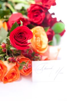 bouquet of colorful roses and a card with the words thank you