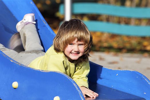 portrait of child playing on colorful playground 