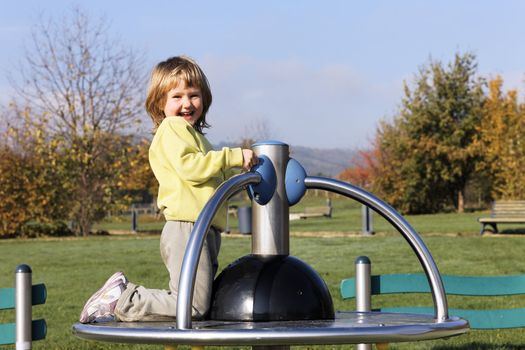 child playing on playground in a park