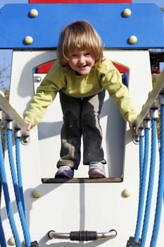 joyful child playing on colorful playground