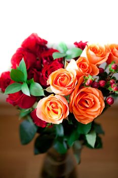 bouquet of colorful roses in a vase on white background