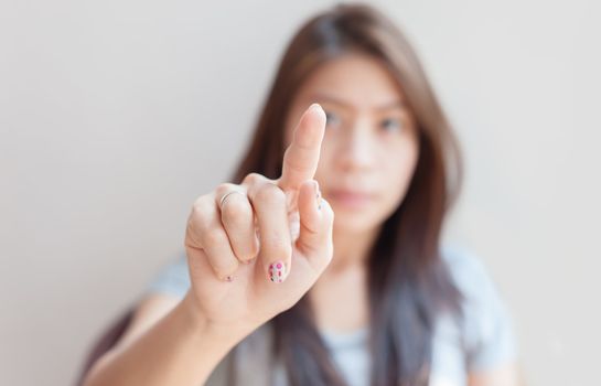 asian woman pressing an imaginary button empty space for buttons