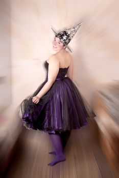 Girl dressed in a fairy costume purple-black, radial background