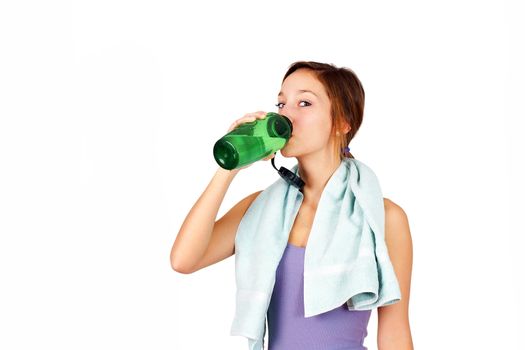 Sporty young woman drinking water after her work-out