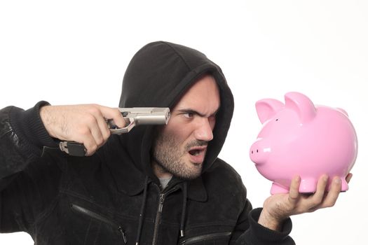 man with gun and pink piggy bank in studio
