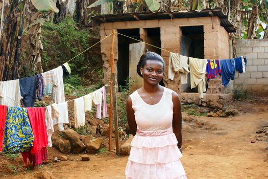 Beautiful young African woman in backyard with clothesline