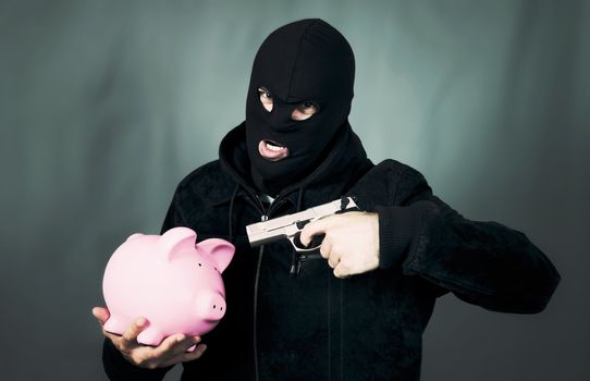 man with a gun and piggy bank, special photographic processing