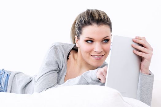 woman on sofa with tablet at home