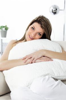 beautiful young woman resting on sofa at home