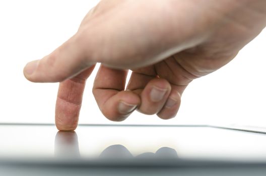 Close up of male hand using a touch screen device. Over white background.