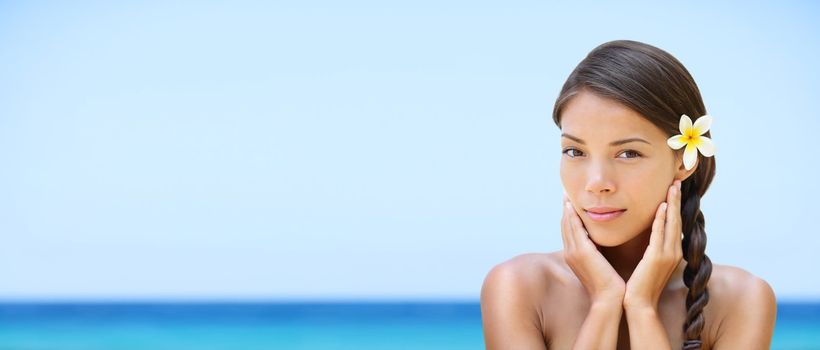 Spa woman on travel beach resort with perfect skin for beauty skin care. Beautiful mixed race Caucasian Asian ethnic girl looking serene a camera during holidays vacation. Panoramic banner on beach.