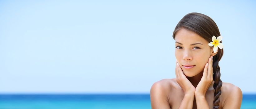 Spa woman on travel beach resort with perfect skin for beauty skin care. Beautiful mixed race Caucasian Asian ethnic girl looking serene a camera during holidays vacation. Panoramic banner on beach.