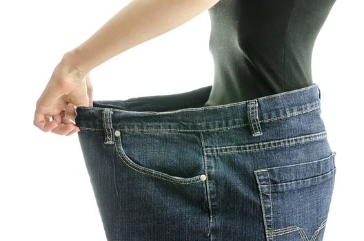 Side view of skinny woman in too large jeans. Concept of successful weight loss.