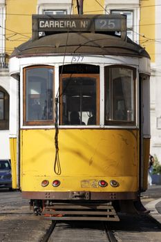 Typical yellow Tram in old street, Lisbon, Portugal 