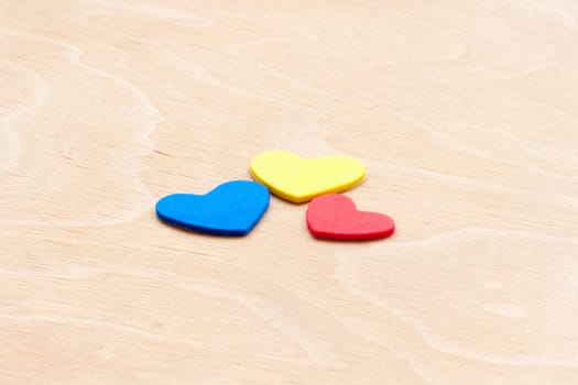 multicolored hearts on a white wooden background. Valentine's Day