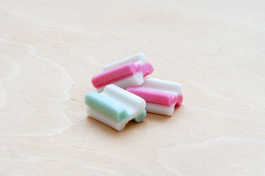 tasty bubble gum on white wooden background