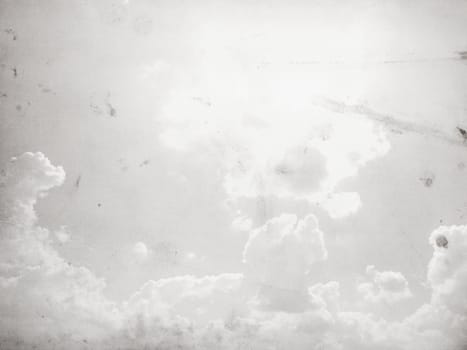 Fog and clouds on a vintage, textured paper background with a color gradient.