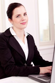 young successful business woman working on computer in office