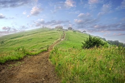 settlement in the mountains among the green pastures