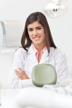 Portrait of beautiful young female dentist at her office smiling