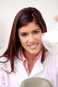 Portrait of an attractive young woman dentist looking at the camera