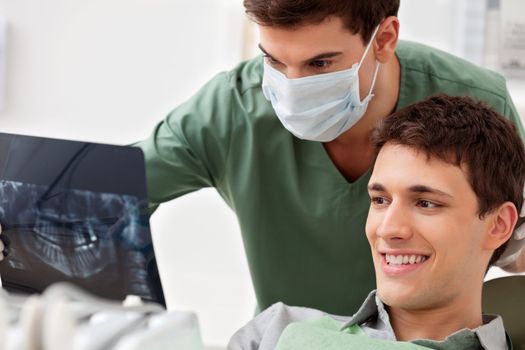 Dentist showing x-ray to the patient